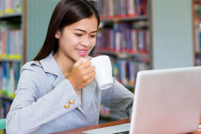Portrait of a young woman drinking coffee cup