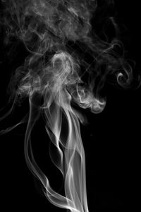 Close-up of smoke against black background