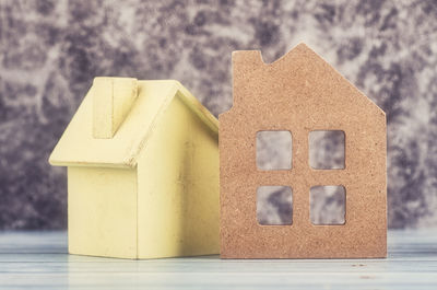 Close-up of yellow toy on table against building