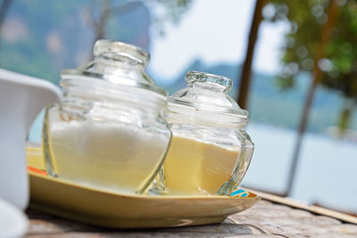 Close-up of glass containers on table