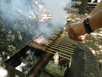 Man preparing food on barbecue grill