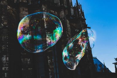 Low angle view of bubbles against building