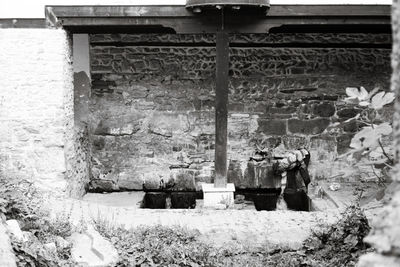 Abandoned building against snow covered wall