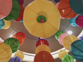 Low angle view of lanterns hanging against sky