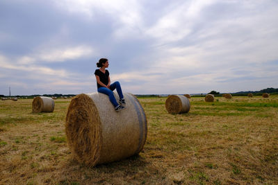 Hay bales on field against sky