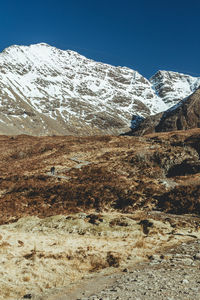 Scenic view of snowcapped mountains against clear sky