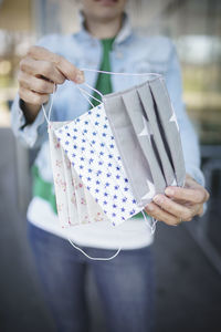 Close-up of woman holding flu mask