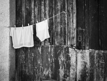 Clothes drying against wall in old building