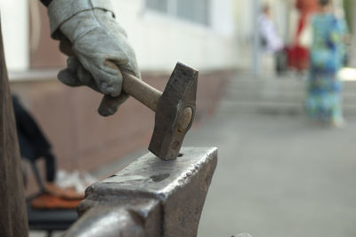 Low section of man holding metal