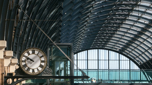 Low angle view of clock on bridge in city