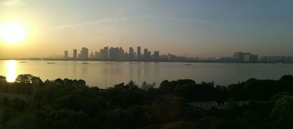 Scenic view of buildings against sky during sunset