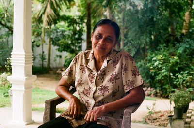 Portrait of woman sitting on a chair