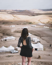 Rear view of woman standing on land