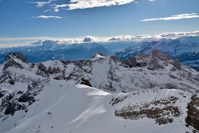 Scenic view of snow covered mountains against sky