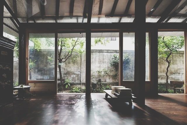 window, indoors, glass - material, architecture, transparent, built structure, tree, house, day, absence, table, potted plant, sunlight, empty, home interior, building exterior, glass, window sill, no people, open