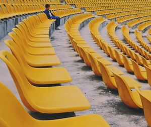 Boy sitting on chair in stadium