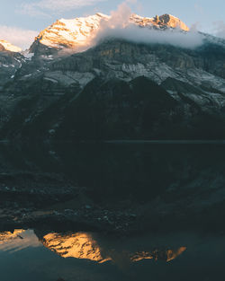 Scenic view of lake against cloudy sky during winter