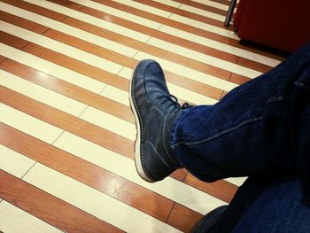 Low section of woman standing on tiled floor