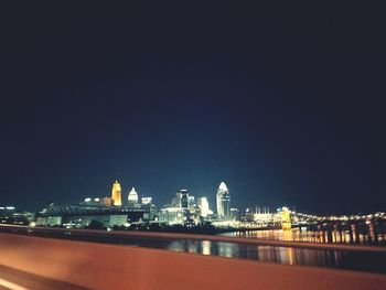 Illuminated cityscape against sky at night