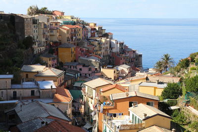 High angle view of townscape by sea against sky