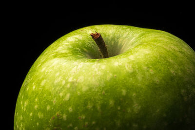 Close-up of apple against black background