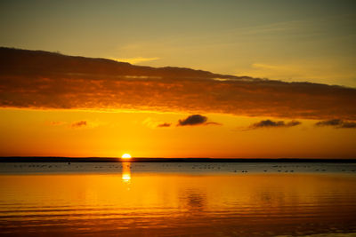 Scenic view of sea against romantic sky at sunset