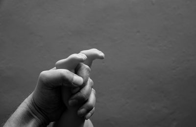 Cropped hand of father holding baby feet