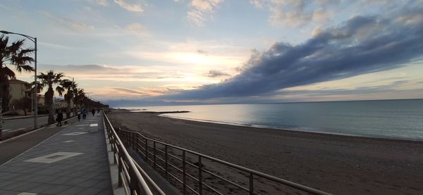 Scenic view of beach against sky during sunset