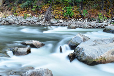 Stream flowing through rocks in forest