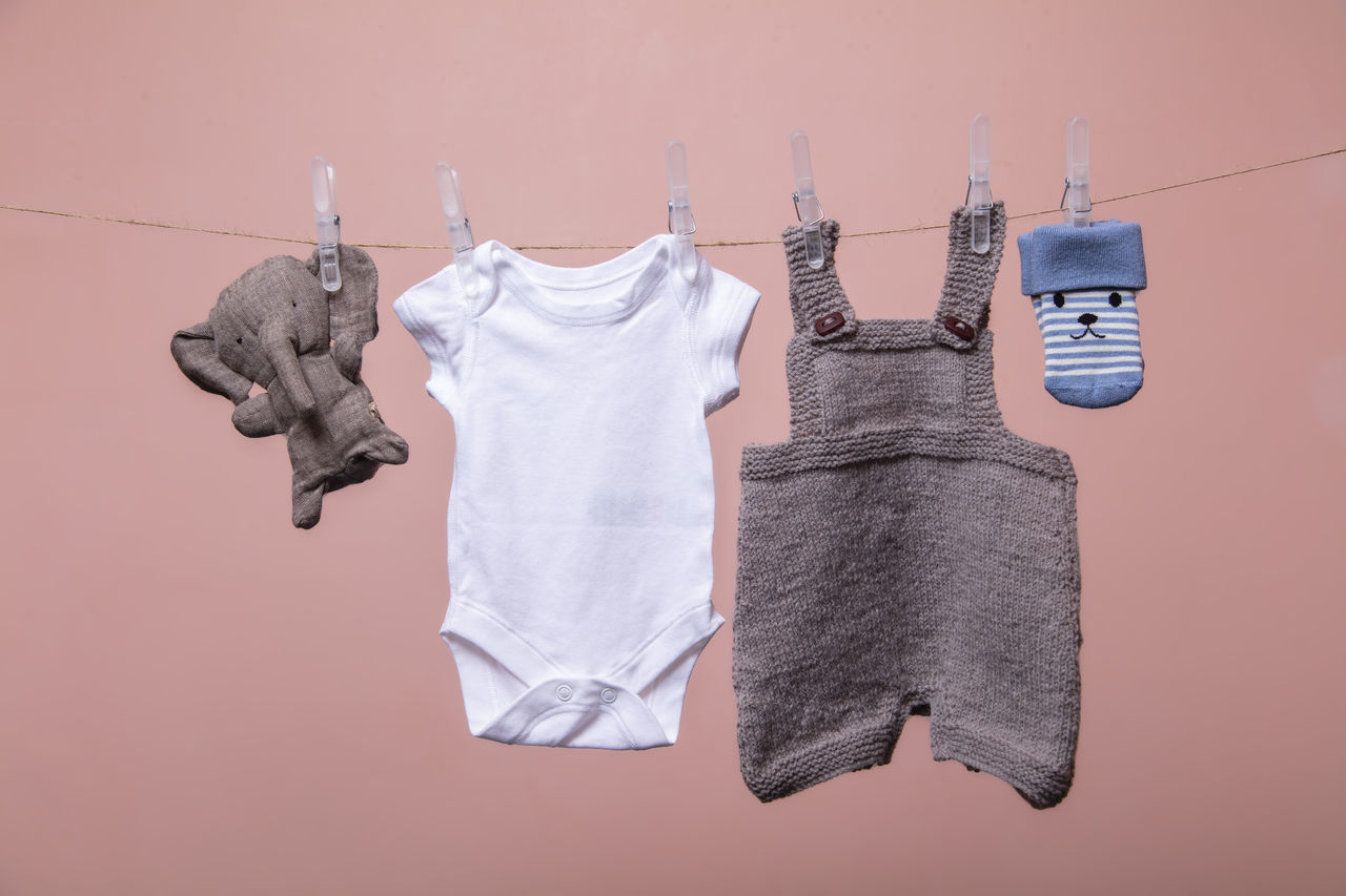 CLOSE-UP OF CLOTHES DRYING AGAINST WHITE BACKGROUND