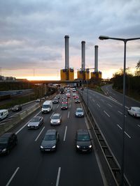 Traffic on road at sunset