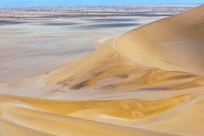 Low section of person on sand at beach