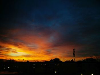 Scenic view of silhouette field against sky at sunset