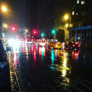 Cars on wet street during rainy season at night