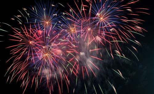 Low angle view of firework display at night