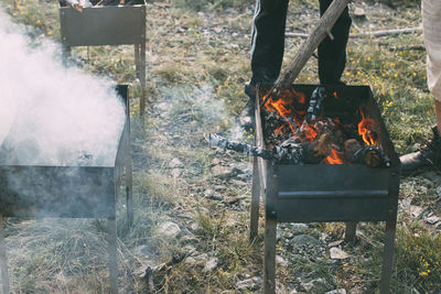 Low section of people standing by fire pit