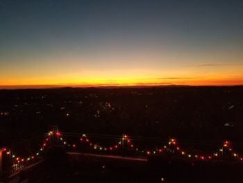 High angle view of city lit up at night