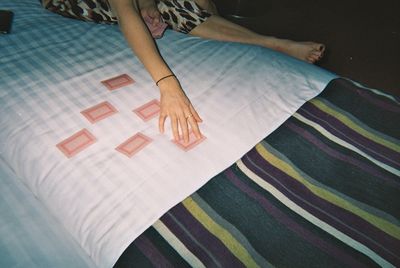 High angle view of woman relaxing on bed at home