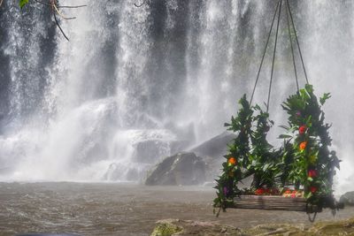 Scenic view of waterfall against trees