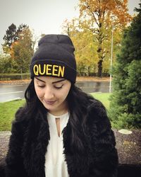 Woman wearing knit hat with text