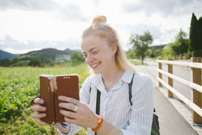 Woman photographing with cell phone