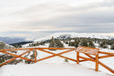 Snow covered landscape against sky