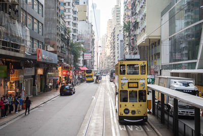 Vehicles on road along buildings