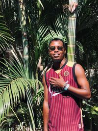 Portrait of woman standing against plants