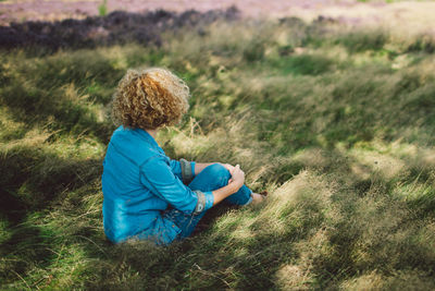 Rear view of woman standing on field