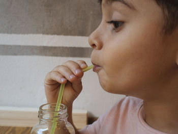 Close-up of boy drinking juice in glass