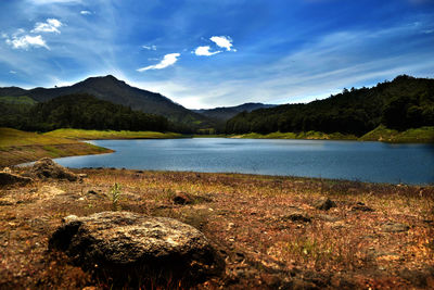 Scenic view of lake against cloudy sky