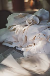 Close-up of white paper on bed at home