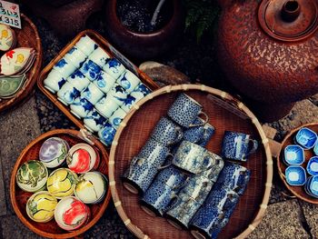 Directly above shot of ceramics tea cups and bowls for sale at street market