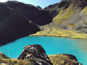 Scenic view of lake and mountains against sky